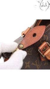 Sold Attire Louis Vuitton Monogram Speedy 25 brown coated canvas bag with vachetta leather trim and brass hardware.