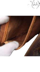 Sold Attire brown Louis Vuitton Monogram Speedy 25 interior pocket detail with vachetta leather trim and brass zipper.