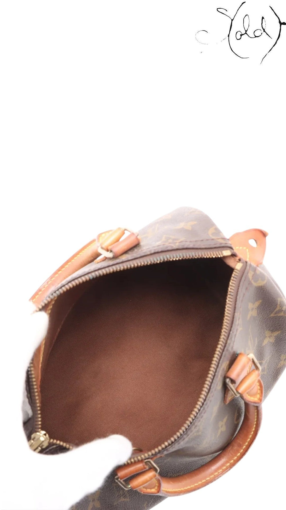 Sold Attire brown Louis Vuitton Monogram Speedy 25 coated canvas bag with vachetta leather trim and brass hardware.