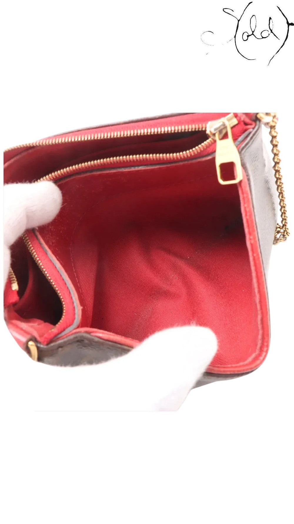 Sold Attire pre-owned Louis Vuitton Pallas Clutch interior with vibrant red textile lining and gold-tone zipper pull.