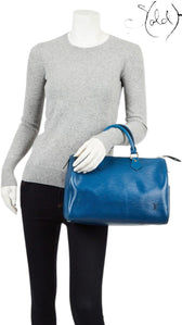 Sold Attire vintage Louis Vuitton Speedy 30 bag in Toledo blue Epi leather with gold hardware held by a mannequin.