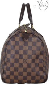Sold Attire brown Damier Ebene coated canvas Louis Vuitton Speedy 30 bag with leather trim and handles.