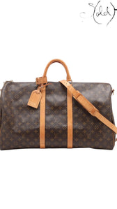 Sold Attire Louis Vuitton Keepall Bandoulière 55 travel bag in brown Monogram coated canvas with natural leather trim.