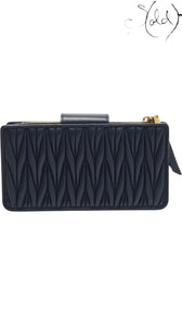 Sold Attire navy matelasse leather phone bag with gold tone zipper and clasp closure, 2019.