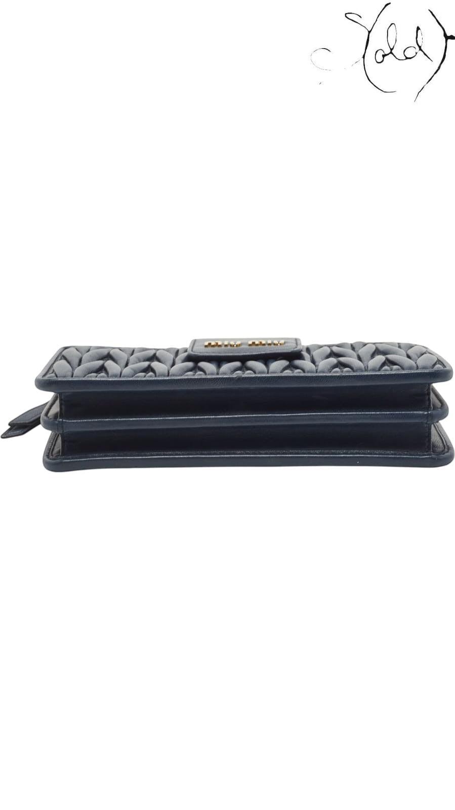 Sold Attire navy blue matelasse leather Miu Miu phone bag with gold tone logo detail.