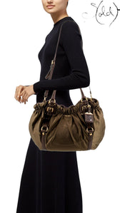 Sold Attire model wearing a brown Prada Tessuto nylon jacquard tote bag with leather trim and gold-tone hardware.