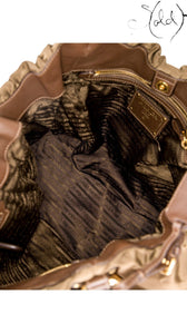 Sold Attire interior view of a brown Prada Tessuto nylon jacquard tote bag featuring logo lining and gold-tone hardware.