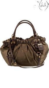 Sold Attire brown Prada Tessuto nylon jacquard tote with leather trim, gold-tone hardware, and rolled handles.