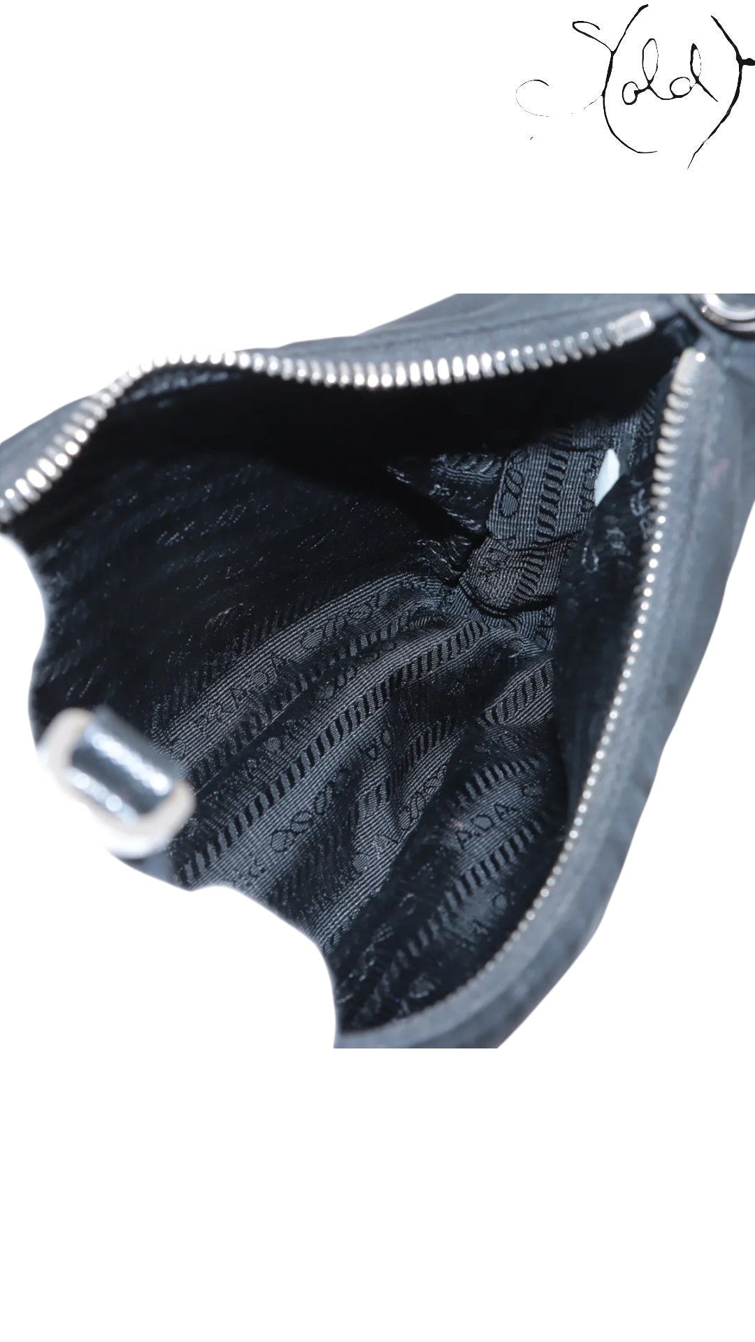 Sold Attire black Prada Re-Edition 2005 nylon shoulder bag with silver hardware and Prada logo jacquard lining.