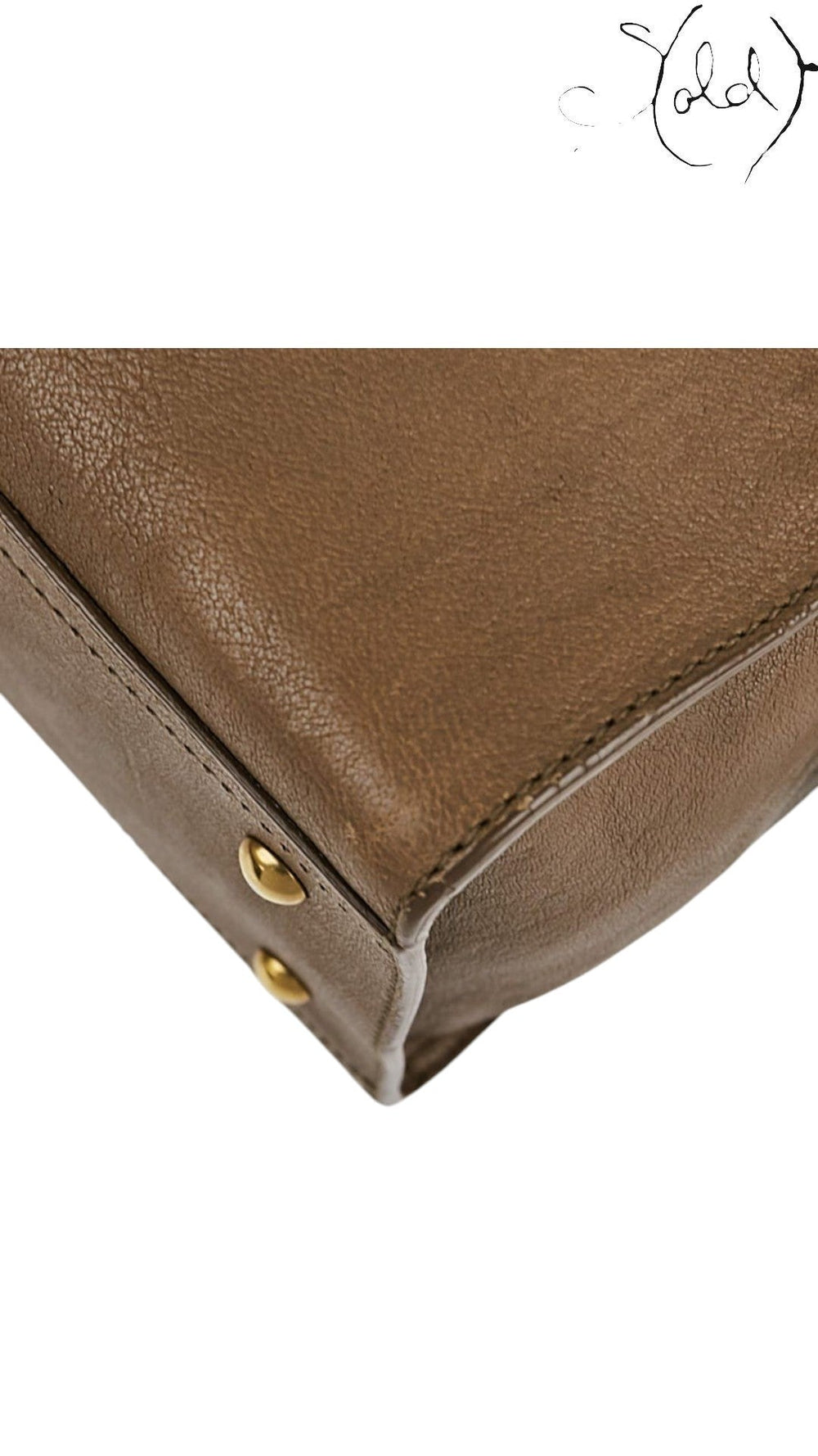 Sold Attire Saint Laurent Cabas Chyc bag corner detail showing brown sheepskin leather and gold-tone protective feet