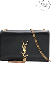 Sold Attire black leather Saint Laurent Kate crossbody bag with gold YSL logo and tassel detail.