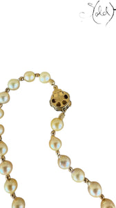 Sold Attire cream Akoya pearl necklace and bracelet set featuring detailed silver SV clasps on a textured fabric background