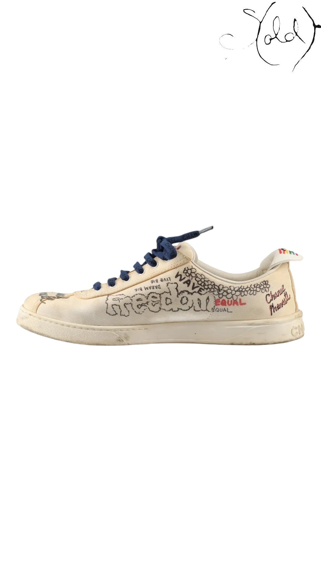 Sold Attire Chanel x Pharrell low-top canvas sneakers in white with multicolor graphic prints and dark blue laces.