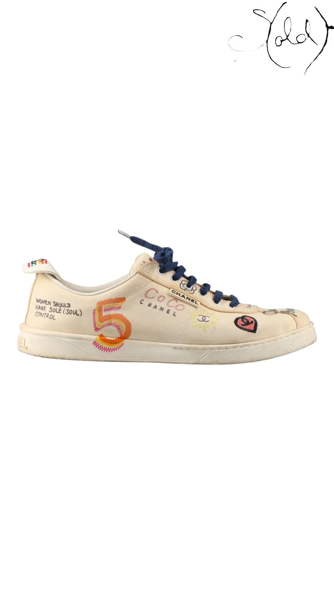 Sold Attire pre-owned Chanel x Pharrell low-top sneakers in white canvas with multicolor graphic COCO print and laces.