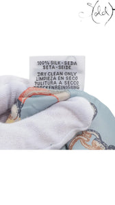 Sold Attire Hermes Twilly silk scarf care label showing 100% silk composition and dry clean only instructions
