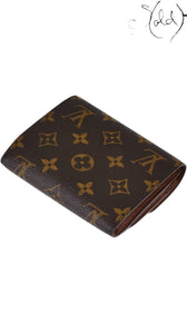 Sold Attire Louis Vuitton Joey wallet in brown Monogram coated canvas with a compact folded design.