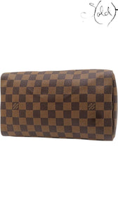 Sold Attire Louis Vuitton Speedy 25 handbag in brown Damier Ebene coated canvas with a classic checkerboard pattern.