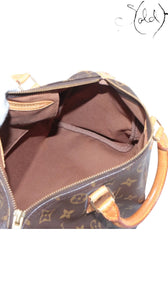 Interior view of a vintage Sold Attire Louis Vuitton Speedy 30 bag showing the clean brown textile lining