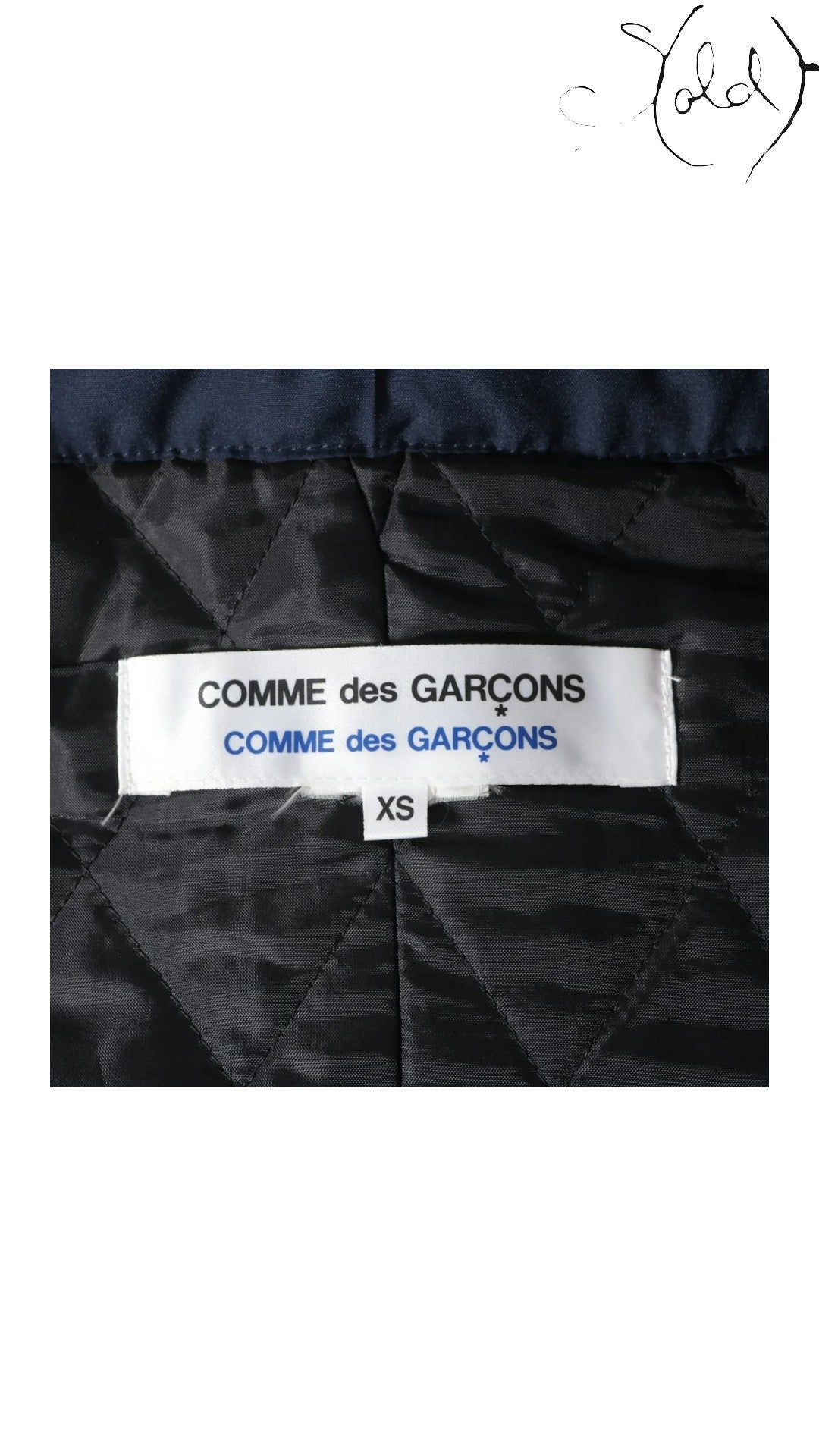 Sold Attire navy polyester padded cape coat from Comme des Garçons AW16 collection, size XS. Features quilted lining and signature branding.