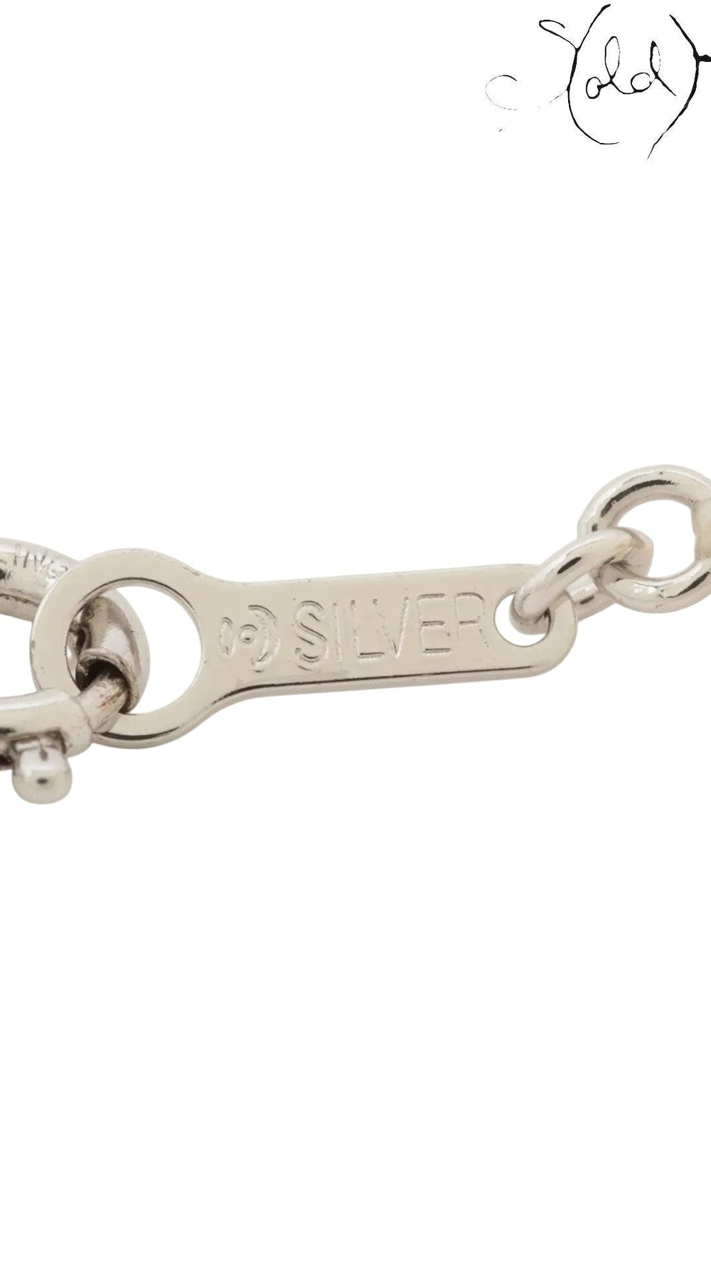 Close-up of the TASAKI pearl necklace silver clasp with hallmark, showing the metal hardware and delicate construction.